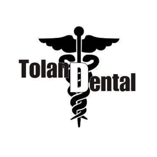 Black caduceus behind Tolan Dental lettering